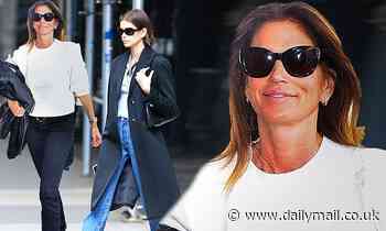 Cindy Crawford jets out of LA in a white sweater while Kaia sports chic black coat in New York