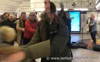Passengers break into joyful conga as busker sings at Tube station