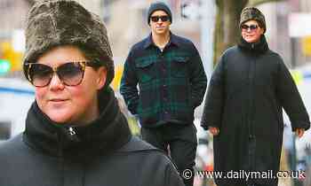 Amy Schumer bundles up out with husband Chris and jokes about 'watching the Oscars in sweatpants' 