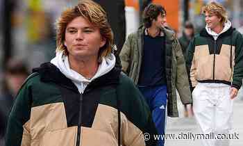 Jordan Barrett braves the chilly weather in a multi-coloured jacket in New York