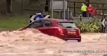 The moment a car gets washed towards a raging river after Storm Dennis floods