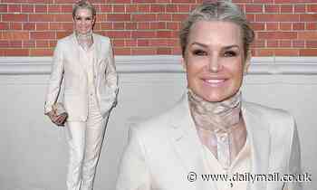 Yolanda Hadid stuns in a chic cream colored pantsuit to support Gigi and Bella on Burberry runway