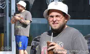 Jonah Hill shows off his tattooed arms as he cuts a casual look for an iced coffee run in LA