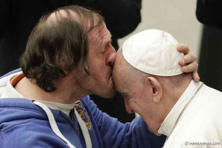 Pope tenderly kissed on forehead by man in front-row seat