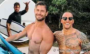 Chris Hemsworth shows off his washboard abs and bulging biceps as he poses with a fan in Byron Bay - Daily Mail