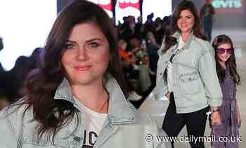 Tiffani Thiessen and her daughter beam while holding hands for a fashion show in Chicago