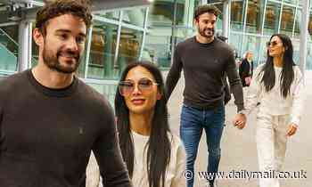 Nicole Scherzinger and boyfriend Thom Evans looked loved-up as they touch down in Heathrow