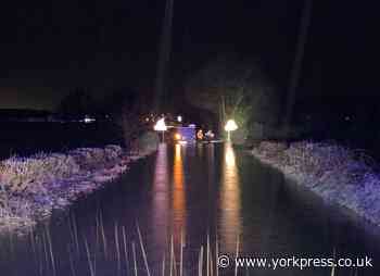 Three rescued from two vehicles which drove into flood water
