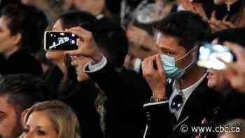 Virus concerns close doors at Armani, but other Milan Fashion Week shows go on