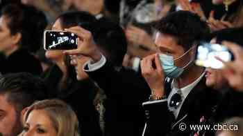 Virus concerns close doors at Armani, but other Milan Fashion Week shows go on