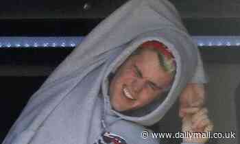 Justin Bieber stretches in his van in LA as he releases music video after topping Billboard 200