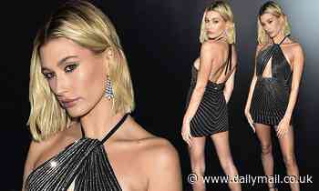 Hailey Bieber displays her endless legs in cut-out glittering mini dress as she attends YSL show
