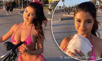 Demi Rose's pink bikini can barely contain her ample assets as she enjoys a sun-kissed bike ride