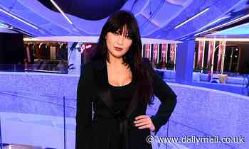 Daisy Lowe looks effortlessly chic in tailored black trouser suit and heels