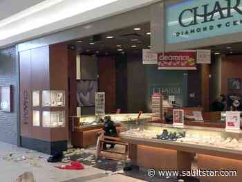 Pair charged in mall robbery, two still sought