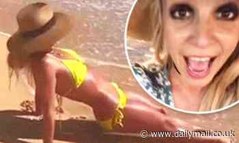 Britney Spears splashes around in a yellow bikini while in Hawaii