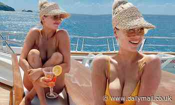Kate Upton puts her bombshell curves on show in bright bikini while sunbathing on a yacht