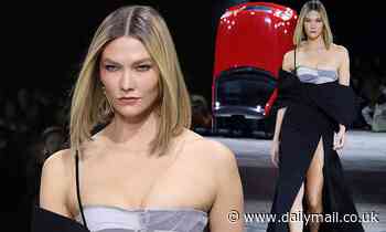 Karlie Kloss flashes her cleavage and toned legs in racy thigh-split corset gown