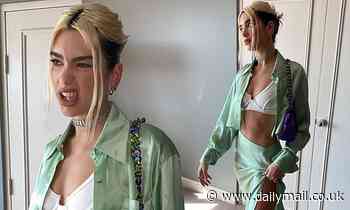 Dua Lipa flaunts her chiseled abs and flashes her bra in a mint green co-ord while in Sydney