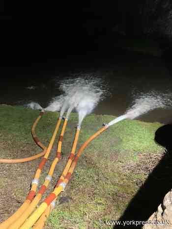 Huge pumping operation underway to try to save village homes from flooding