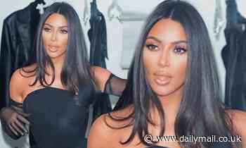 Kim Kardashian sizzles in a black corset and nylon gloves in latest behind-the-scenes snapshot 
