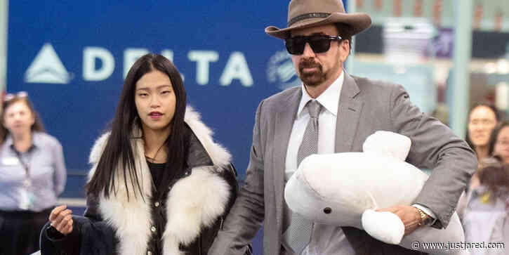 Nicolas Cage Carries a Beluga Whale Toy With New GIrlfriend Riko Shibata at the Airport in NYC