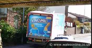 Bread lorry appears to have sliced off part of roof after encountering low railway bridge