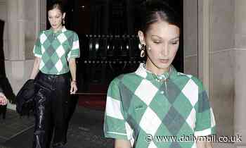 Bella Hadid steps out in leather trousers and a Lacoste top during Paris Fashion Week