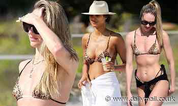 Candice Swanepoel and Lais Ribeiro go wild in leopard-print bikinis as they frolic on the beach