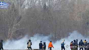 Greek and Turkish police fire tear gas as migrants try to cross into Greece