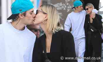 Justin Bieber looks smitten as he plants a kiss on wife Hailey Baldwin while on romantic stroll 