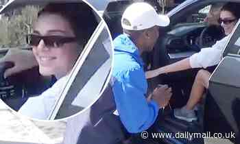 Kendall Jenner laughs as a fan drops to his knees to propose as she steps out her car