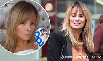 Rhian Sugden cuts a casual figure in a plunging T-shirt and jeans