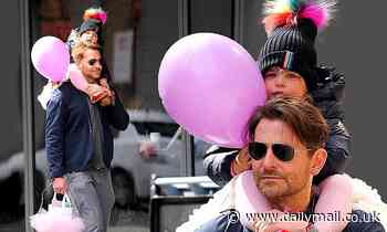 Bradley Cooper proves he is a doting dad, as he sweetly carries his daughter home in NYC