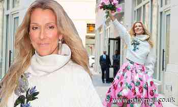 Celine Dion matches her pink floral dress to her bouquet as she greets fans outside her NYC hotel