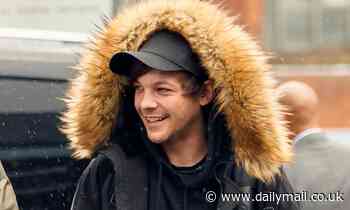 Louis Tomlinson wraps up in a fur trim coat as he jets to Barcelona to begin his tour