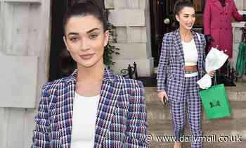 Amy Jackson showcases her taut waist in an elegant tweed suit and crop-top