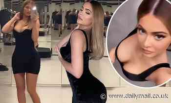 Kylie Jenner admires her figure in full length mirror as she models tight little black dress
