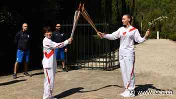 Amid virus precautions, Tokyo Olympic flame is lit in Greece