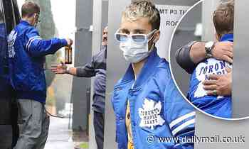 Justin Bieber wears a mask but then shakes a man's hand, hugs him