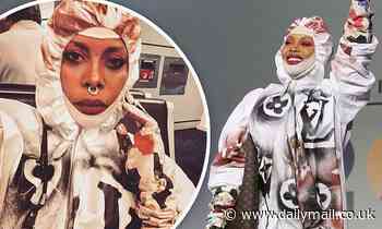 Erykah Badu steps out in a Louis Vuitton hazmat suit to accept award in Texas amid coronavirus fears