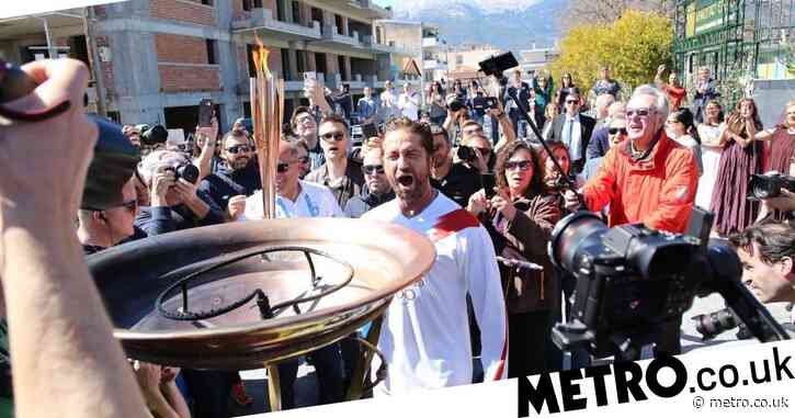 Gerard Butler beside himself as he carries Japan 2020 Olympic torch before relay is suspended