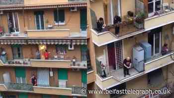 ‘My street came alive’: Rome sings anthem from balconies during lockdown
