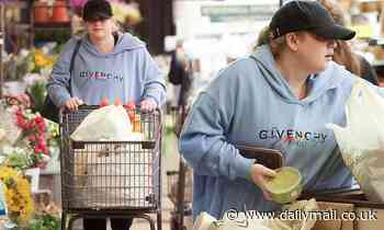Rebel Wilson cuts a casual figure in a Givenchy grey hoodie as she stockpiles food