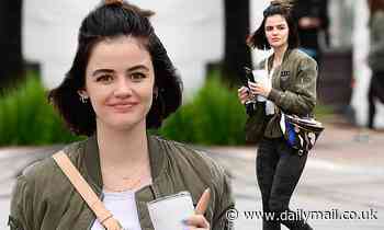 Lucy Hale flashes a smile in camouflage leggings as she steps out for a gym session