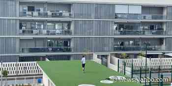 Fitness trainer leads neighbors in group workout during coronavirus lockdown in Spain