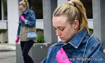 Dakota Fanning wears pink latex gloves amid coronavirus outbreak