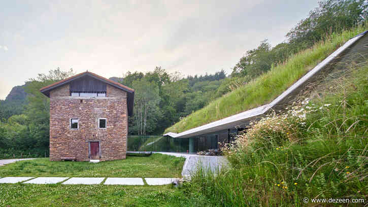 Glass corridor connects underground concrete extension to house in Spain