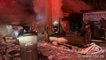 Saskatoon firefighters called to garage fire while putting out dumpster one block away