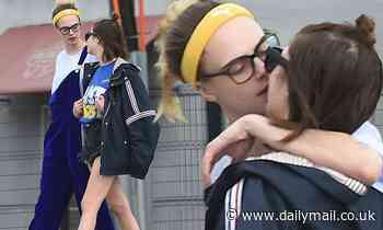 Cara Delevingne comforts Ashley Benson with a kiss as they take a break from self-isolating